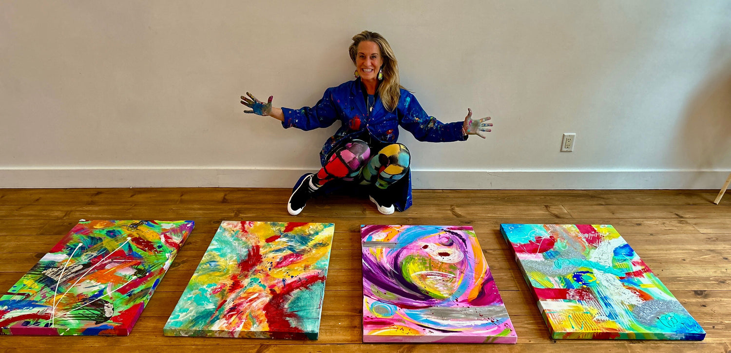 Karo T with paintings created in her Team Masterpiece workshop - coulorful collective paintings 